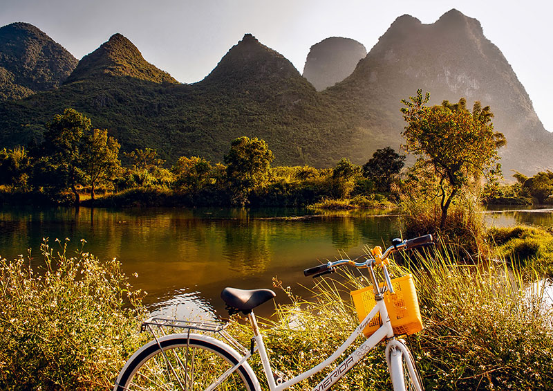 A bicycle parked in front of some mountains