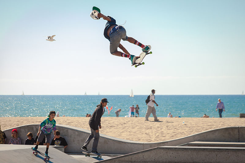 A man flying through the air while riding a skateboard.