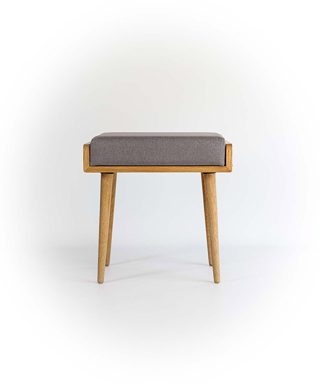 A wooden stool with a gray cushion on top of it.